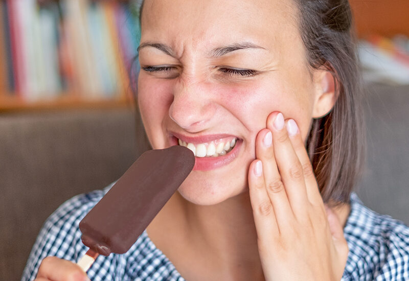 Woman portrait feeling tooth pain at home