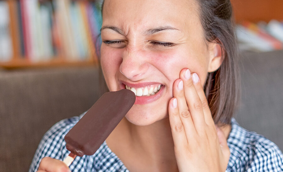 Woman portrait feeling tooth pain at home